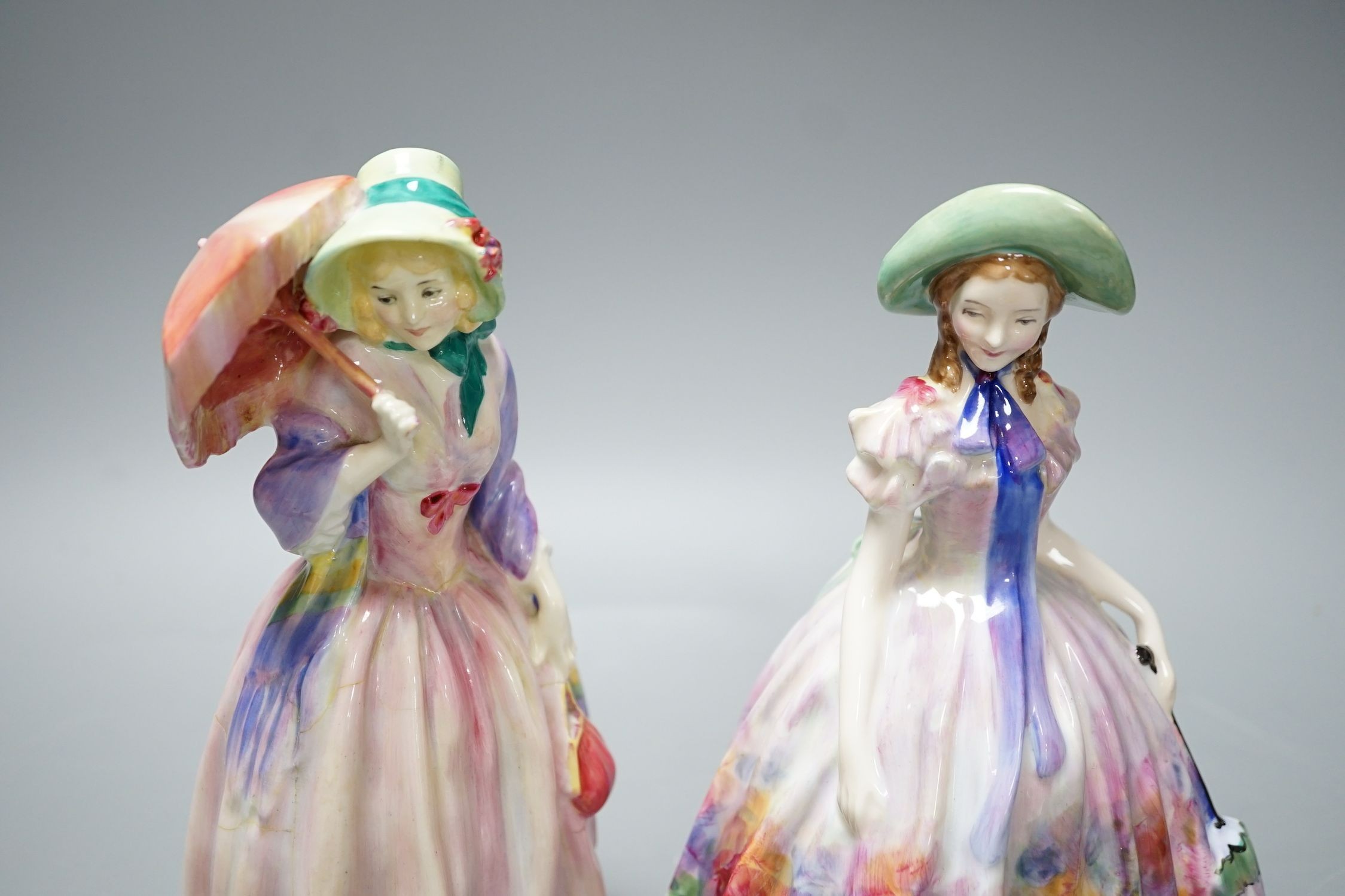 A Royal Doulton figurine: Reg No753474, Miss Demure and an Easter Day figurine: HN 2039, together with three Beswick Kingfisher wall plaques, damage